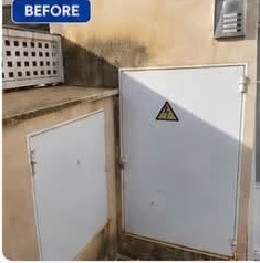 Render wall before cleaning, stained with algae
